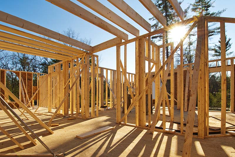 Wood framing of a new house being constructed before home inspection services are scheduled 
